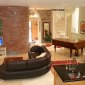 Renovated living room with salvaged red brick wall Renovated living room