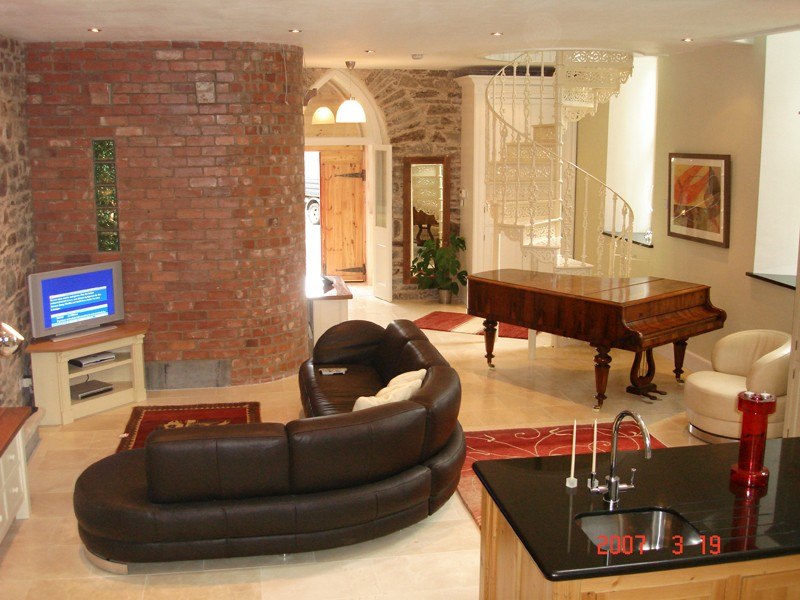 Renovated living room with salvaged red brick wall Renovated living room